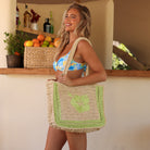 girl with large straw tote with lime green hibiscus on it